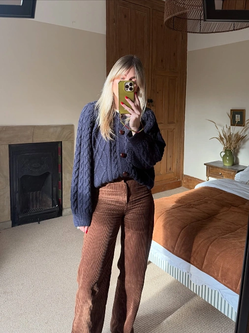 Navy cable cardigan with brown corduroy trousers