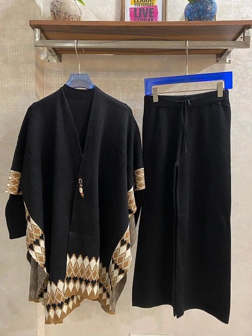 Black poncho with wide-leg pants winter outfit