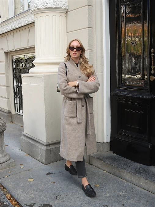 Taupe belted wool coat with dark jeans and loafers