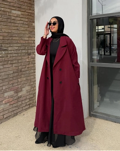 Burgundy coat worn over black outfit