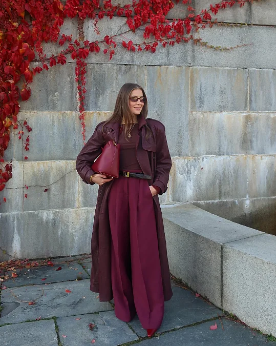 Burgundy leather coat with wide leg trousers